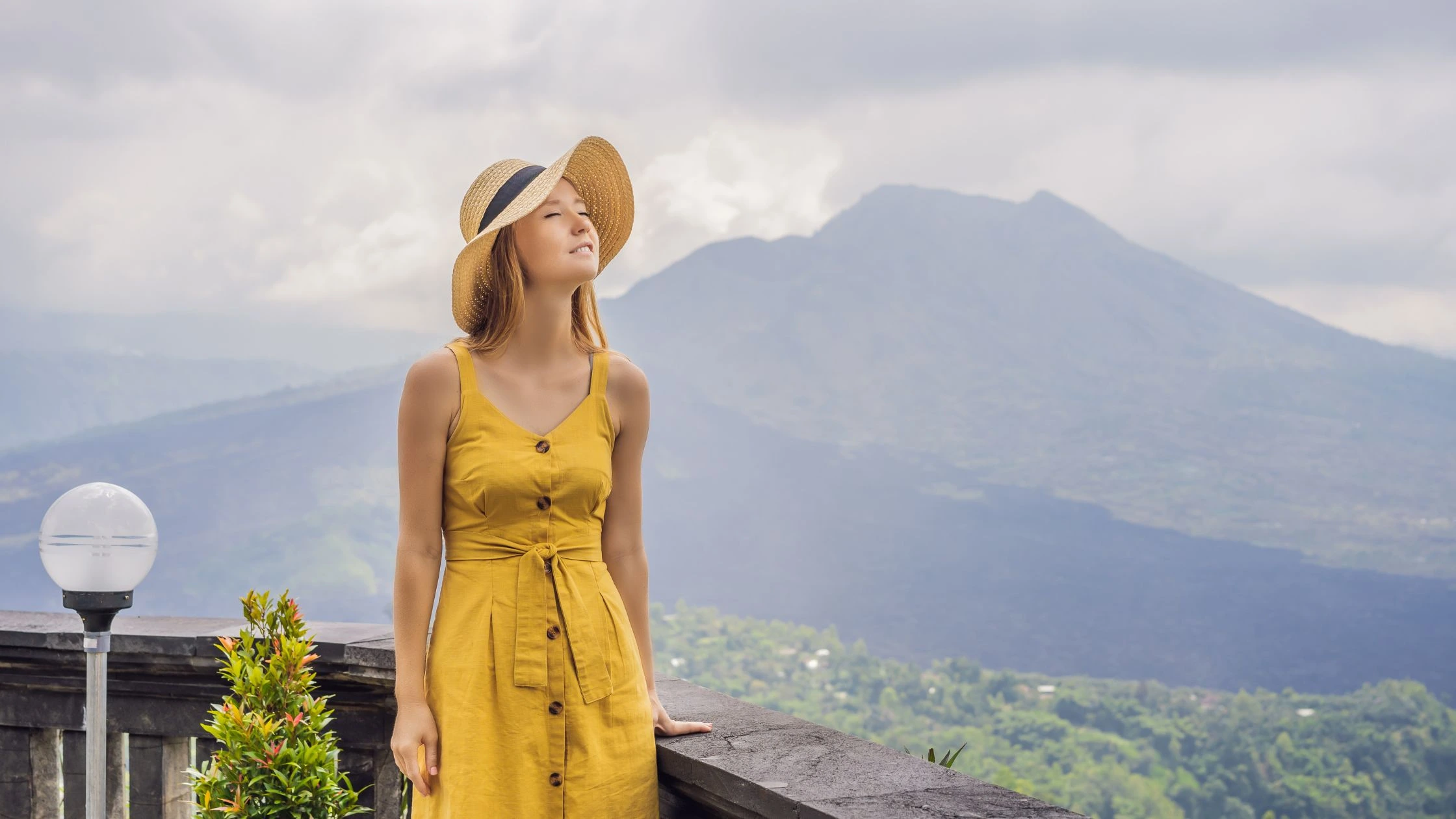 - Bali Adventours A local guide points towards the summit of Mount Batur, leading a small group of adventurers. This image emphasizes the importance of experienced guides for a safe and informative trekking experience.