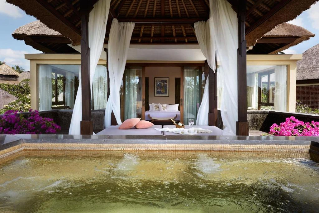 A luxurious villa at Kamandalu Ubud, featuring a private pool and traditional Balinese decor amidst a natural setting.