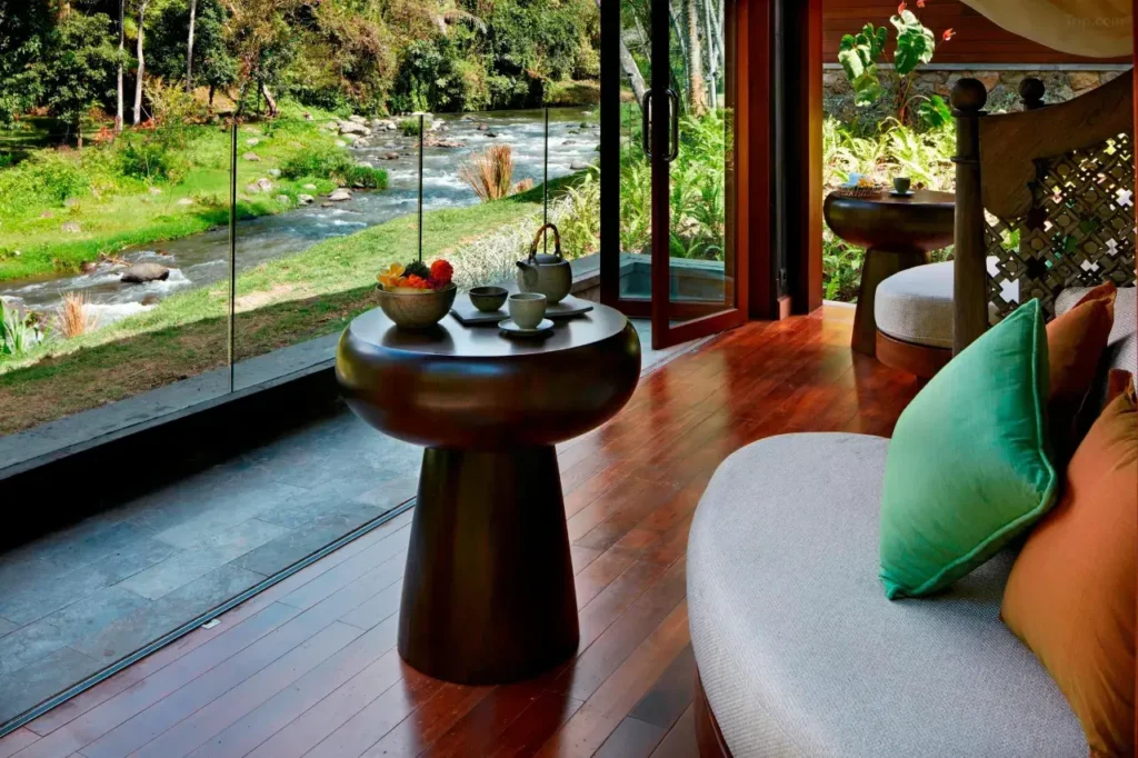 Mandapa a Ritz-Carlton Reserve luxury resort in Ubud, Bali, featuring serene river views and lush jungle landscape.