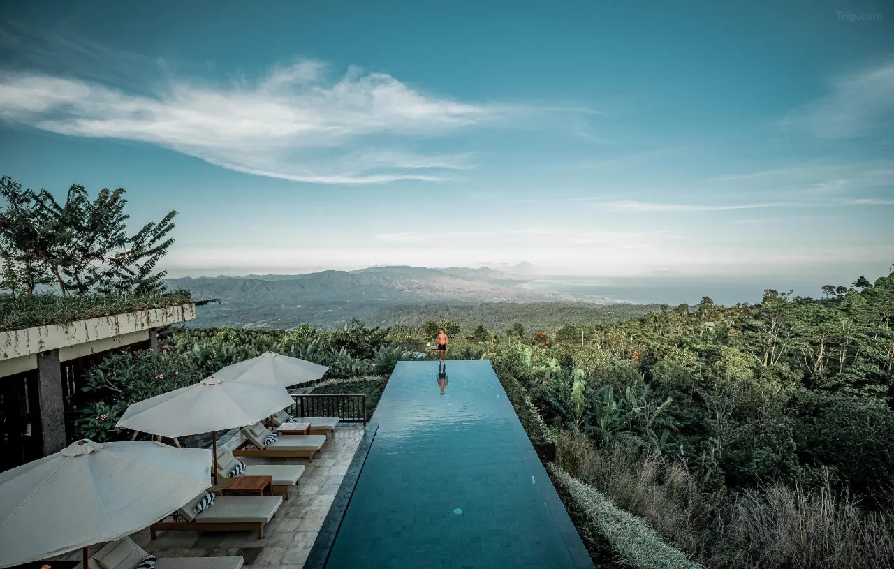 Munduk Moding Plantation Bali resort with private balcony overlooking coffee plantations, mountains, and distant rice fields.