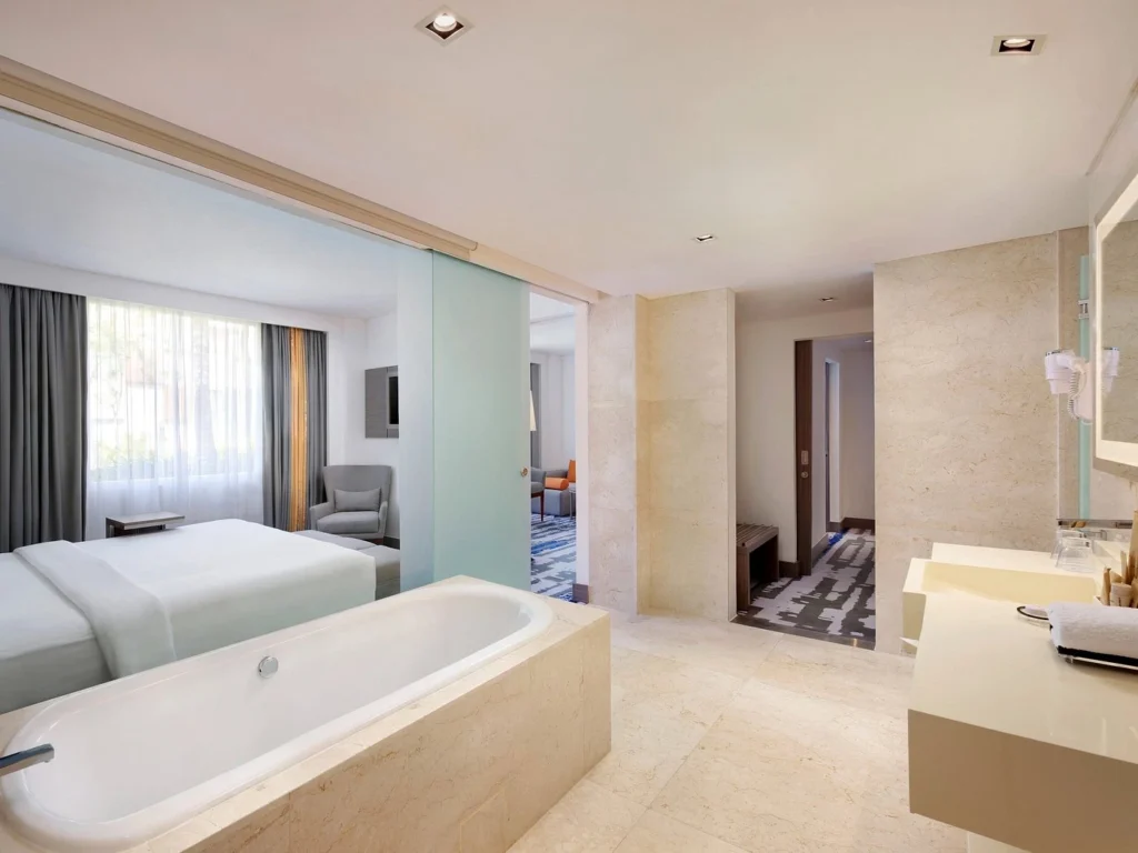 Novotel Bali Ngurah Rai Airport hotel building with outdoor pool, perfect for comfortable transit stays.