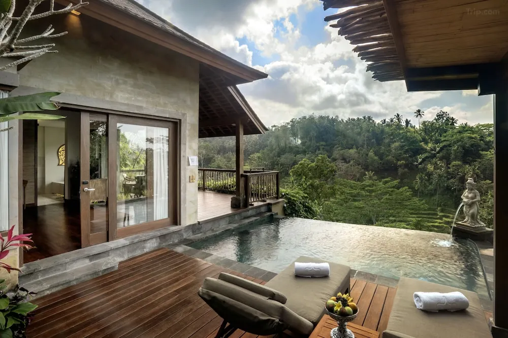 The Kayon Jungle Resort Ubud's private balcony suite with stunning views of the surrounding rainforest and glimpses of rice fields.