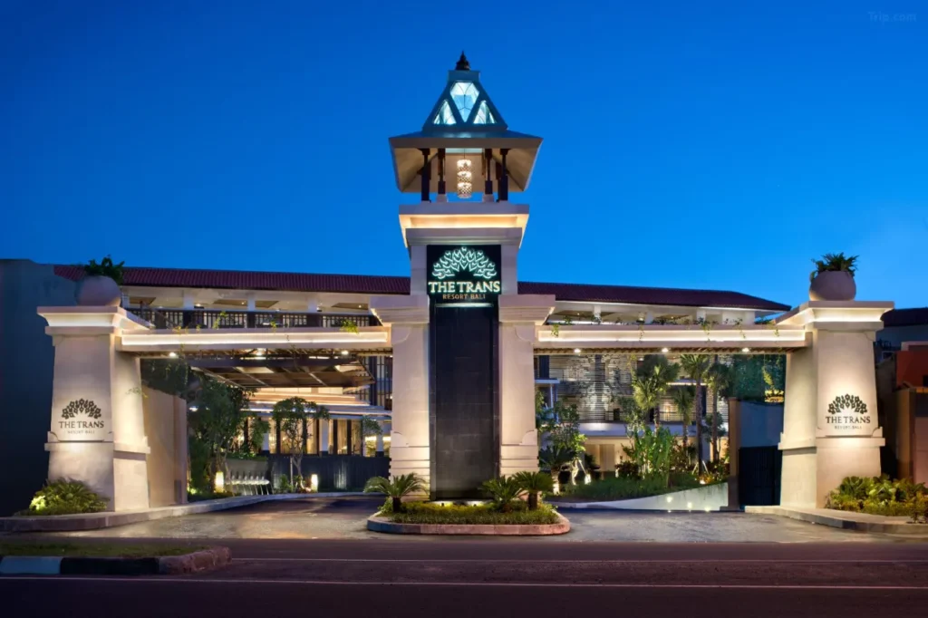 The parking facility at Trans Resort Bali in Seminyak, indicating the availability of free parking for hotel visitors. A sign or vehicles may suggest ease of access.