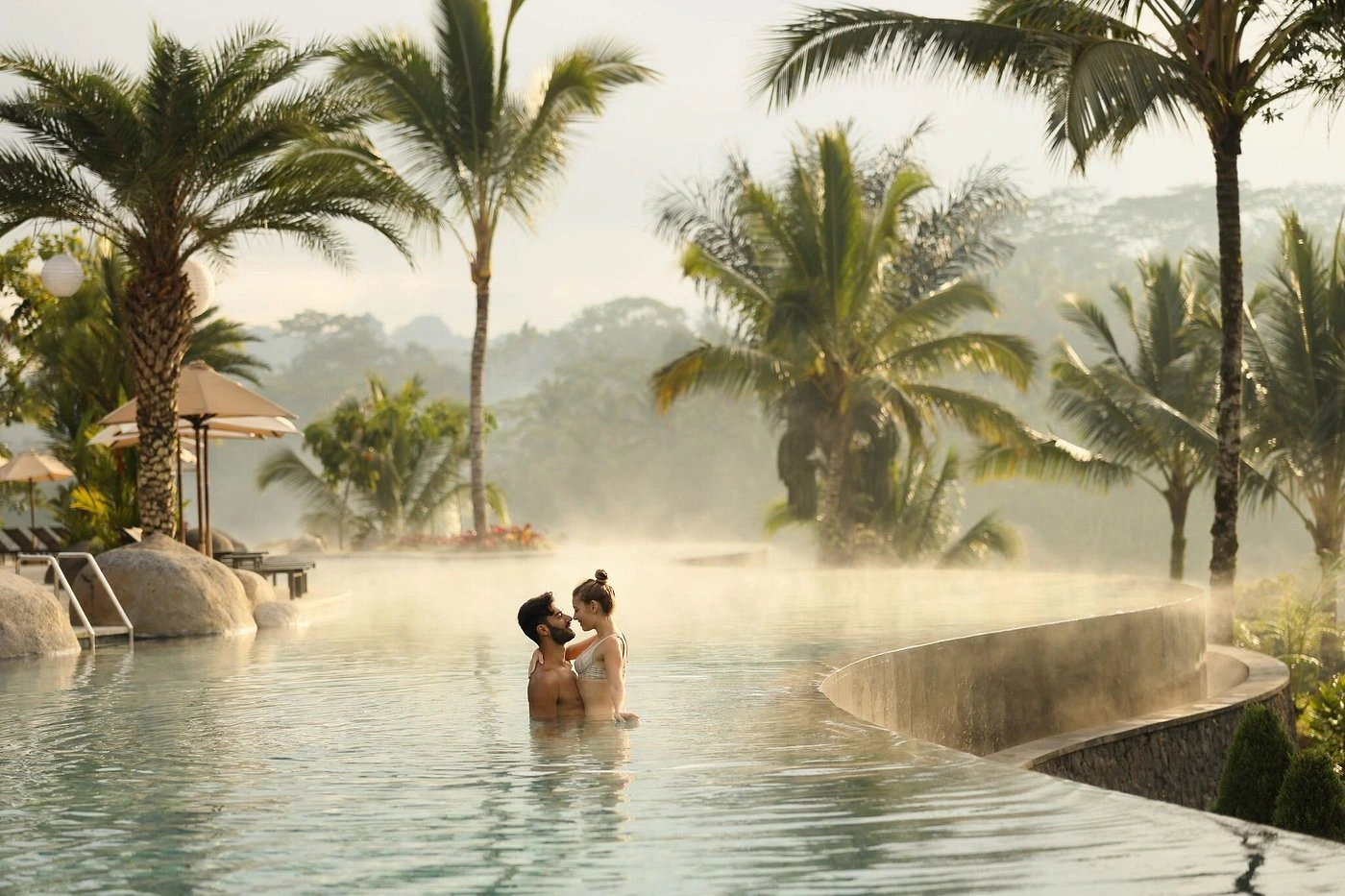 A visually balanced image representing the synergy of Uluwatu and Ubud for a Bali honeymoon. One side features a serene, cliffside ocean view typical of Uluwatu, while the other displays lush, terraced rice fields characteristic of Ubud. The image subtly conveys that combining both destinations, or choosing one with careful planning, leads to a perfect romantic getaway.