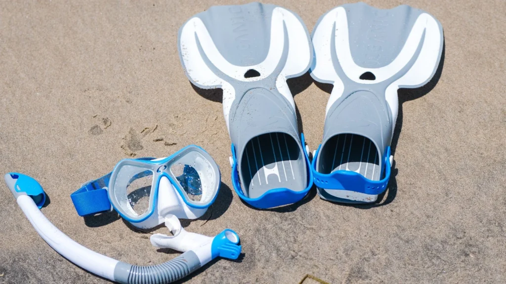 Essential snorkeling gear including masks, snorkels, and fins laid out for a trip in Nusa Penida.