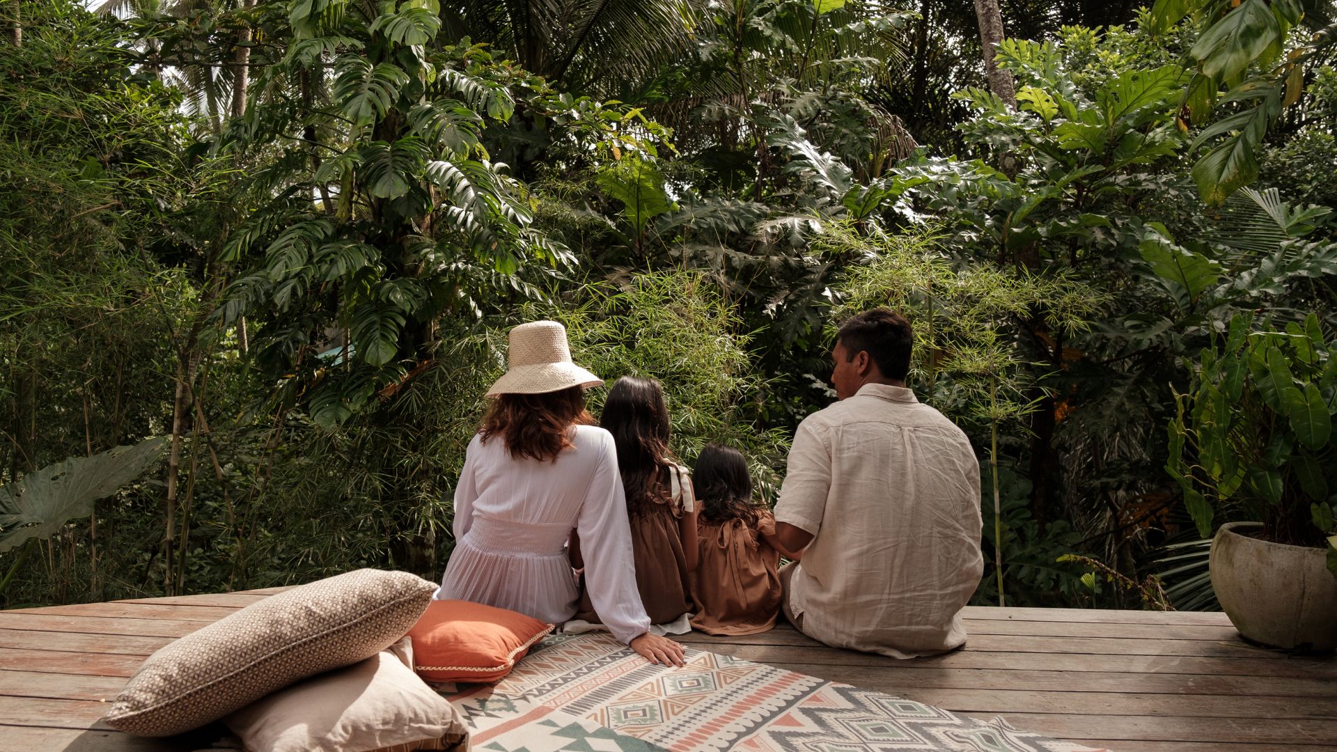 Family enjoying outdoor activities in Bali with kids playing by the beach.