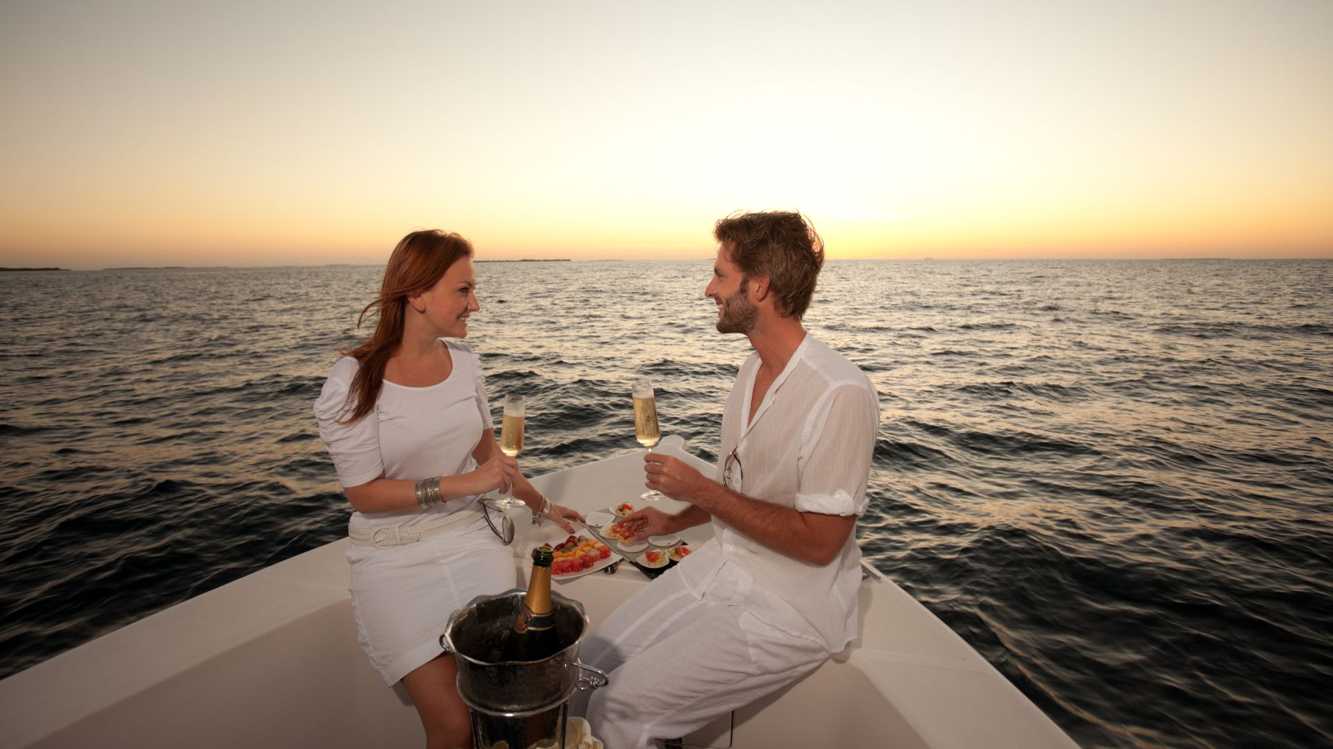 Couple overlooking yacht during a honeymoon trip.