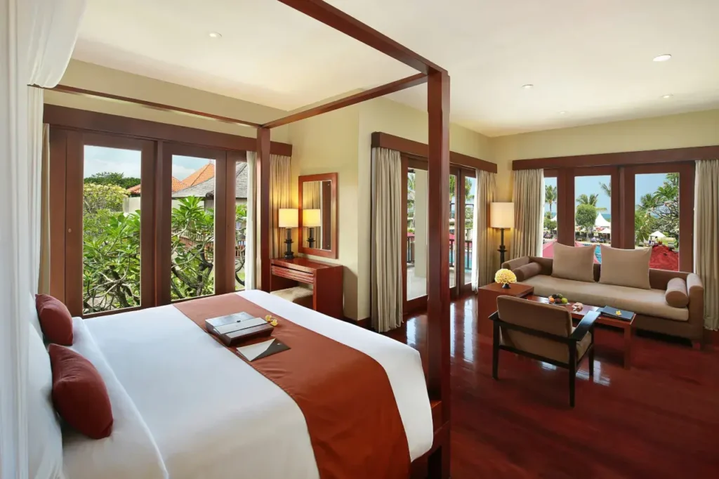 Oceanfront pool and sunset view at Bali Niksoma Boutique Beach Resort in Legian, one of the best beachfront hotels in Bali.