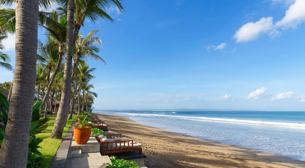 Beachfront Bali hotel with pool, private balcony, and free breakfast tropical escape by the Indian Ocean.