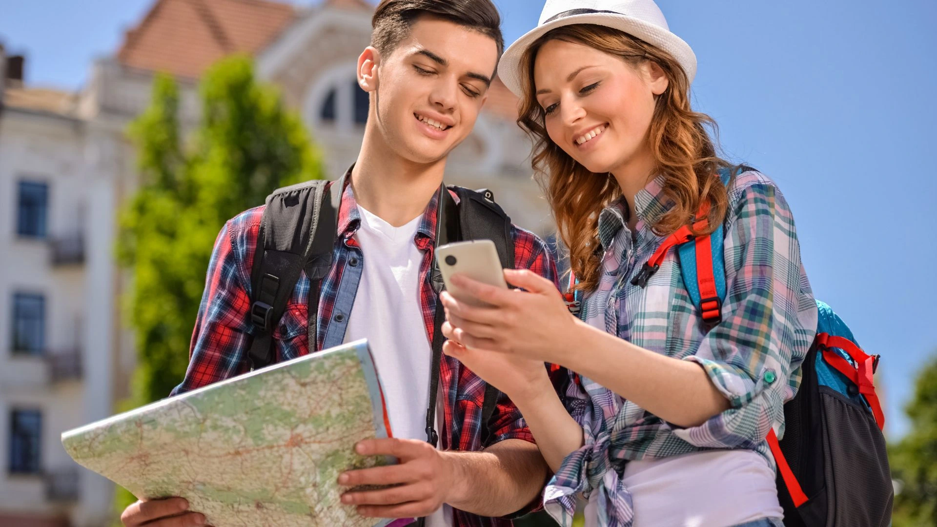 Tourists on vacation in Bali using their smartphone to find information, highlighting the need for a stable internet connection from a local SIM card.