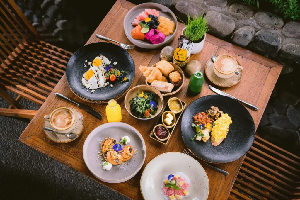 Free breakfast you’ll actually enjoy fresh tropical fruit, pastries, and coffee with a Bali beachfront view.