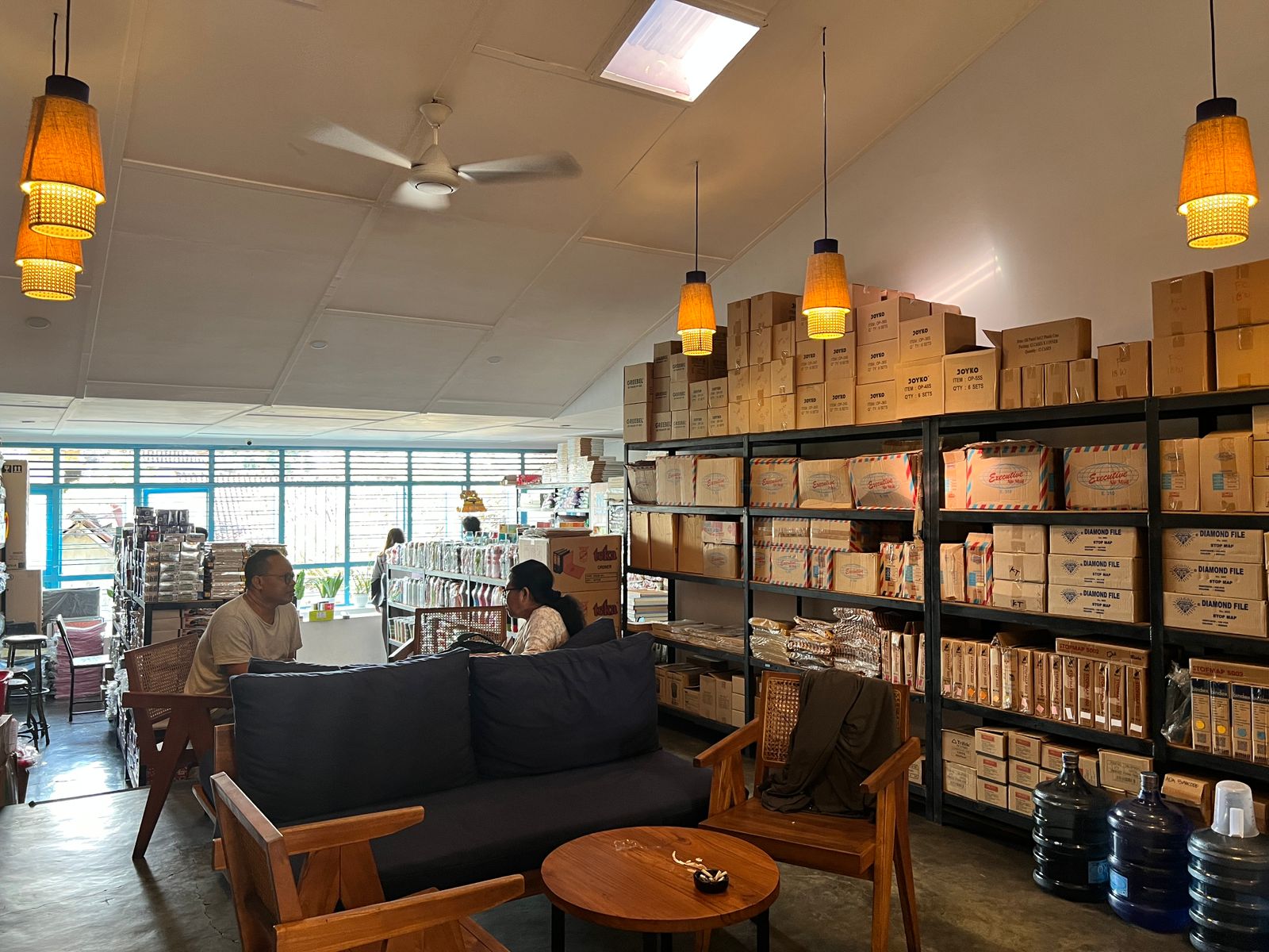 - Bali Adventours A glass cabinet filled with old everyday items — an abacus, ink-stained fountain pens, a pocket watch, and worn notebooks, looking like objects once used and left behind rather than museum pieces.