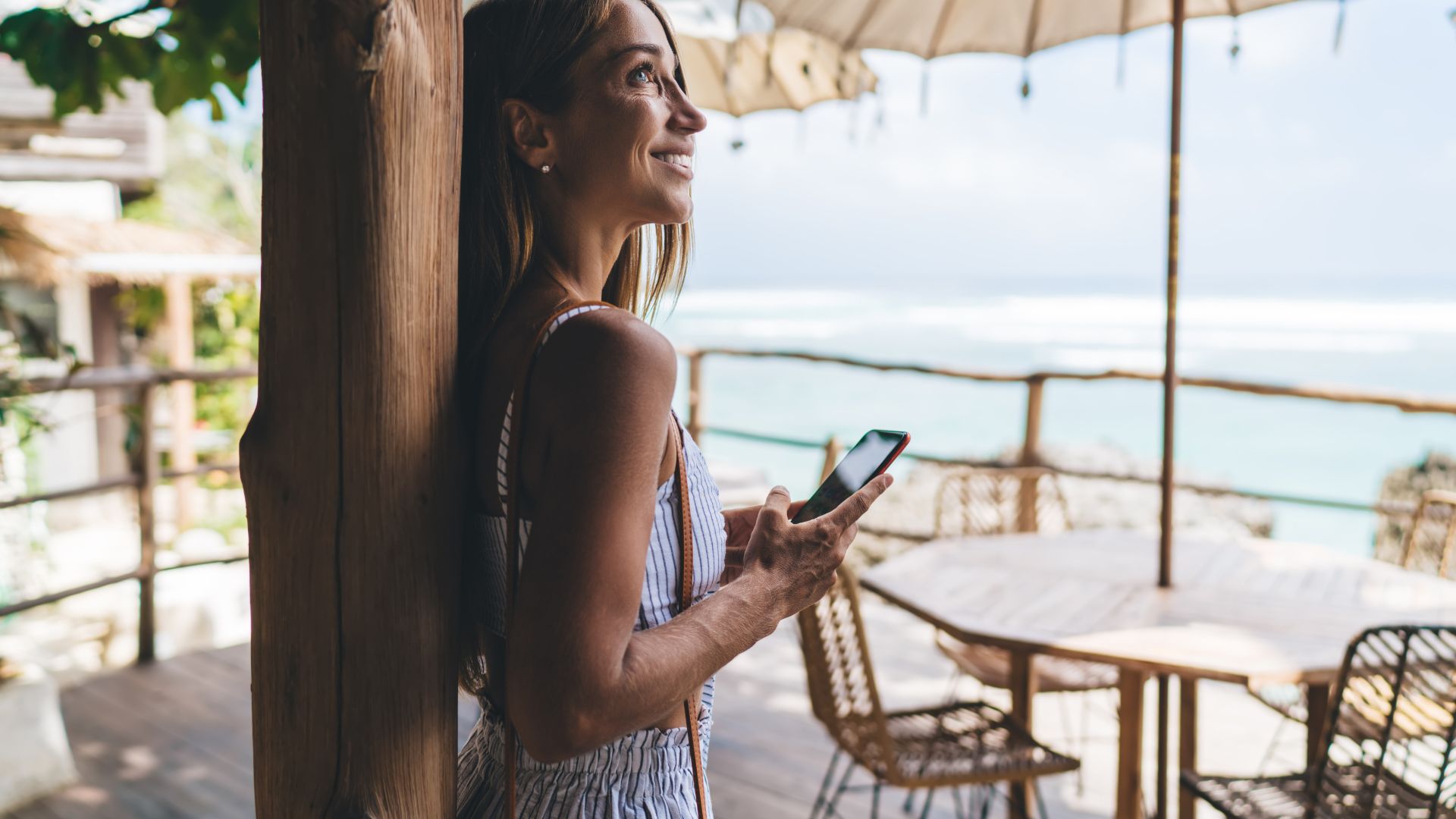 A woman enjoying the view at a nature café in Bali. She looks relaxed while admiring the scenery around her.