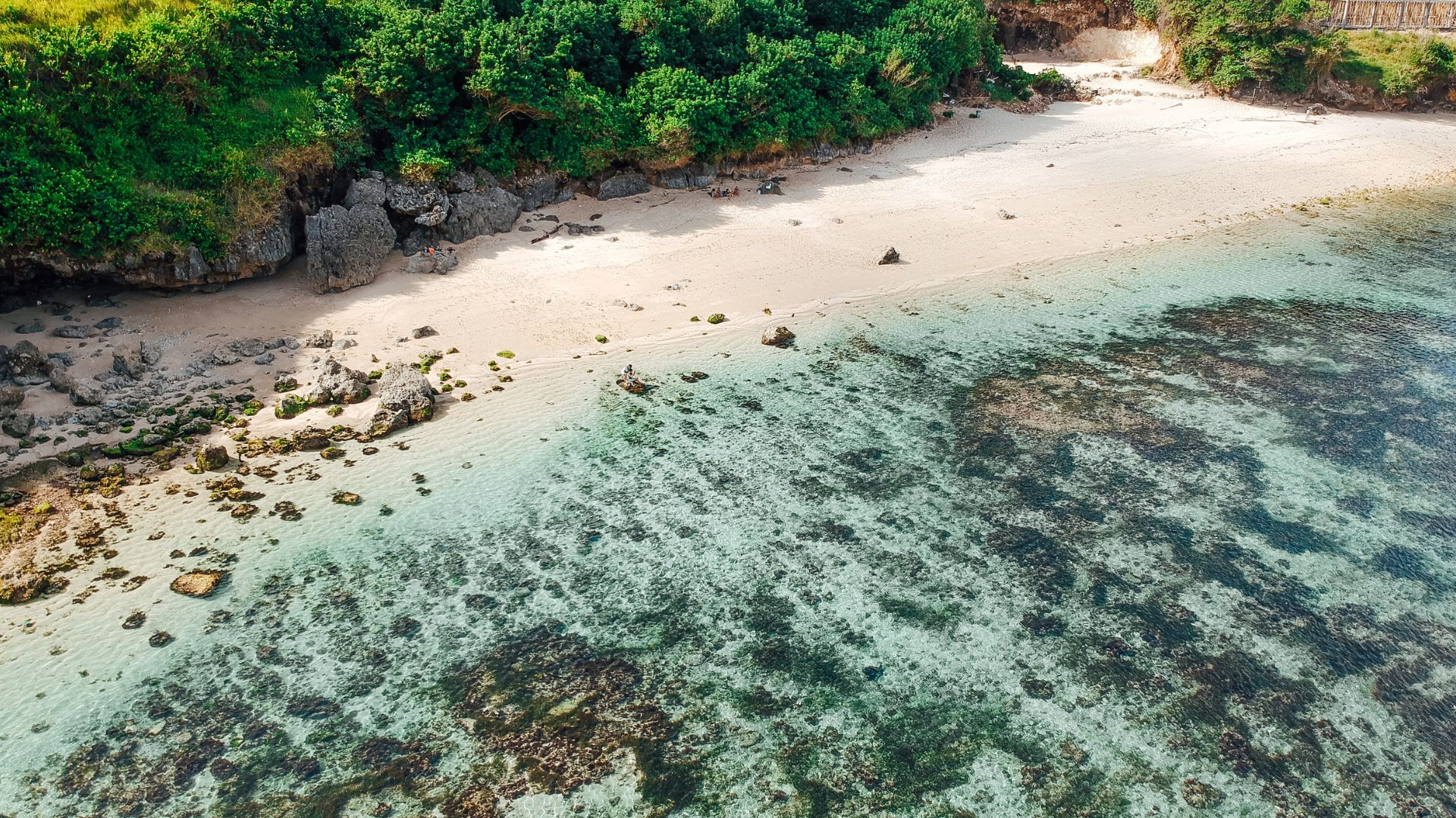 Gunung Payung Beach in Bali with clear blue water and soft sand. The view feels secluded and relaxing.