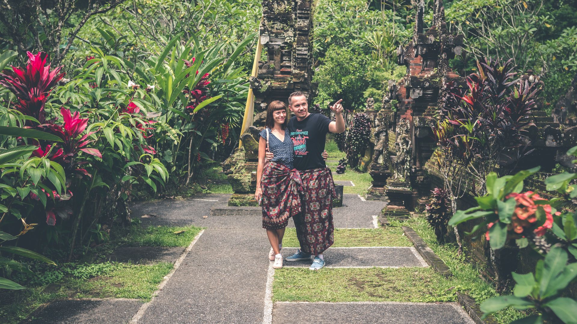 A couple posing for a photo at a tourist spot in Bali. Their private photographer captures the moment during their holiday.